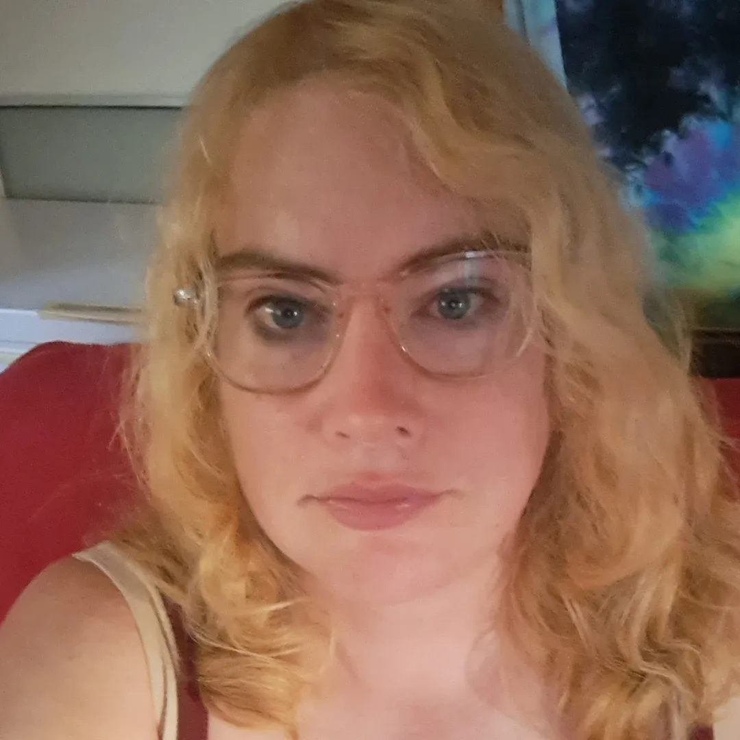 Portrait Of Claire Coleman Wearing Glasses With Blonde Hair Claire Coleman with blonde hair and glasses looking at the camera indoors
