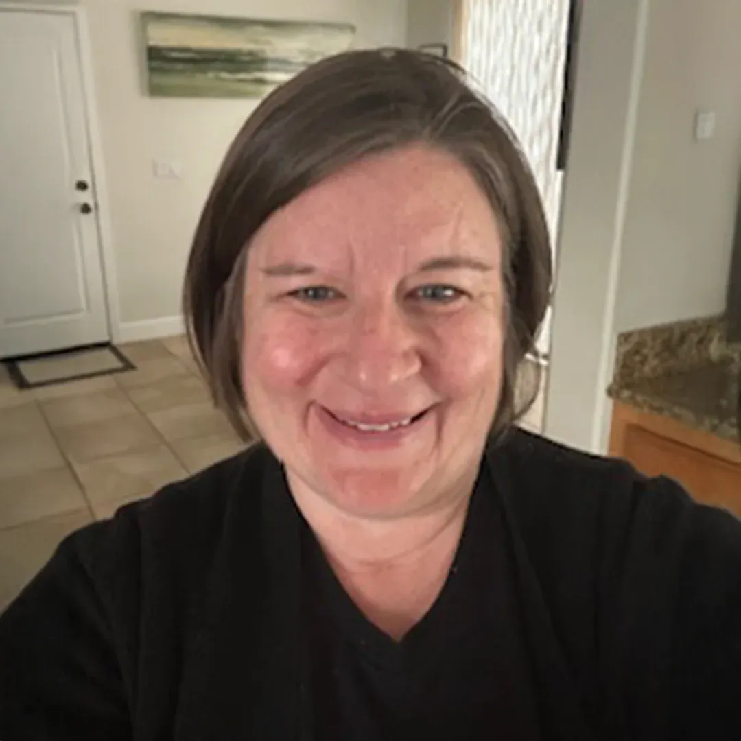 Portrait Of Jen Brookover Smiling Indoors Jen Brookover smiling indoors with a home interior visible in the background